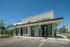 Modern pet center with electric vehicle charging stations, featuring sleek architecture and ample parking.