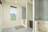 Bright and modern laundry room with geometric tile pattern, featuring ample natural light and sleek design elements.