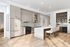Contemporary kitchen with sleek cabinetry, marble island, and modern appliances under elegant lighting.