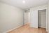 Bright and inviting room with elegant wood flooring, spacious closet with sliding doors, and a clean, modern aesthetic.