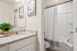 Elegant bathroom with granite countertop, modern fixtures, and stylish decor, offering a serene and inviting atmosphere.