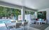Charming outdoor lounge with a poolside view, modern patio seating, and vibrant decor, perfect for relaxation and entertaining.