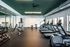 Modern gym with motivational quote wall, featuring spin bikes and state-of-the-art fitness equipment.