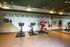 Modern gym with motivational quote wall, featuring spin bikes and state-of-the-art fitness equipment.