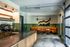 Chic caf&eacute;-style apartment space featuring a modern espresso counter and cozy lounge seating with stylish wall art.