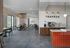 Chic modern cafe space featuring sleek black seating, cozy wooden accents, and vibrant tile backsplash at the coffee bar.
