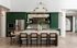 Luxurious modern kitchen with elegant green cabinetry, stylish brass chandelier, and spacious seating area.