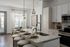 Bright and modern kitchen with sleek countertops, elegant pendant lighting, and a cozy dining area perfect for entertaining.