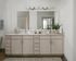 Elegant bathroom with double sink vanity, large mirror, and stylish lighting.