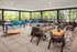 Chic open-air lounge with modern seating, vibrant decor, and scenic views.