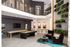 Chic and modern entertainment area featuring a stylish billiards table, cozy seating with lush greenery accents, and elegant lighting.