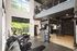 Bright, modern gym with state-of-the-art exercise equipment, large windows, and stylish loft design.