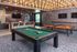 Luxurious entertainment room featuring a stylish pool table, modern lighting, and a chic ping pong table, perfect for leisure and gatherings.