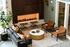 Chic and modern lounge area with a cozy fireplace, elegant seating, stylish decor, and lush greenery.