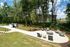 Inviting outdoor patio with cozy seating surrounded by lush greenery, perfect for relaxing and enjoying nature.