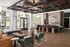 Elegant and modern lobby area with stylish seating, wooden accents, and abundant natural light through large windows, creating a welcoming atmosphere.
