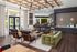 Modern lounge area with stylish wooden ceiling accents, contemporary geometric wall design, and plush green seating, offering a sophisticated atmosphere.