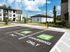 Modern apartment complex with EV charging stations, showcasing eco-friendly living and contemporary design.