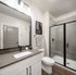 Modern bathroom design featuring elegant fixtures, sleek vanity, and a spacious glass shower.