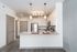 Modern kitchen with sleek stainless steel appliances, elegant granite countertops, and stylish pendant lighting.