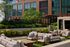 Luxurious outdoor terrace with stylish seating, lush greenery, and modern apartment backdrop, perfect for relaxation and entertaining.