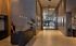 Elegant apartment lobby showcasing modern design with sleek black marble reception desk, warm lighting, and contemporary decor.