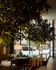 Luxurious lobby with elegant seating area surrounded by lush greenery and large windows offering city views.