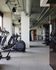 Modern, well-equipped gym with sleek exercise machines and spacious layout, perfect for fitness enthusiasts in a luxury apartment complex.