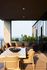 Luxurious outdoor patio featuring elegant furniture, lush greenery, and stunning skyline views.