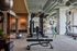 Modern gym facility with advanced fitness equipment, a weight machine, and exercise areas, perfect for an energetic workout session.