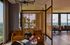 Elegant living space with modern decor, featuring plush armchairs, a cozy dining area, and stunning panoramic views.