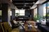 Sophisticated modern living room with stylish seating, ambient lighting, and lush greenery, creating a cozy yet contemporary atmosphere.