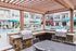 Luxurious apartment complex featuring a stylish outdoor lounge area with grills, modern patio seating, and a refreshing pool surrounded by elegant apartments.