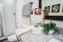 Modern bathroom oasis with elegant granite countertop, round mirror, and vibrant succulents beside stylish decor.
