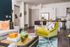 Inviting open-concept living space with modern kitchen, vibrant decor, and cozy seating area perfect for relaxation and entertaining.