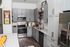 Modern kitchen with sleek gray cabinets, granite countertops, and stainless steel appliances for a stylish home.