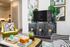 Chic and modern living room with vibrant decor, featuring stylish furniture, green accents, and a sleek TV setup.
