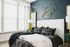 Luxurious bedroom with elegant decor featuring a plush bed, modern gold wall art, and stylish dual lamps.