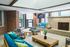 Chic modern living room with cozy seating, stylish fireplace, and large windows for natural light.