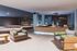 Elegant lobby area with plush seating, modern water feature, and ambient lighting.