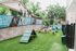 Charming pet-friendly outdoor area featuring agility equipment, lush greenery, and a welcoming atmosphere perfect for playful dogs.
