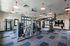 Modern fitness center with state-of-the-art gym equipment, stylish lighting, and large windows for an invigorating workout experience.