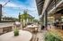 Inviting outdoor patio with modern seating, string lights, and a built-in barbecue grill, perfect for entertaining and relaxation.