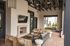 Chic outdoor lounge with cozy seating, fireplace, and TV, perfect for relaxation and entertainment.