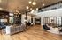 Elegant apartment lobby with modern lighting, wooden floors, and stylish seating areas perfect for relaxation and social gatherings.