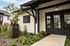 Charming exterior of Livano Pet Center featuring modern black and white design, vibrant landscaping, and an inviting entrance.