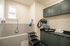 Elegant utility room featuring a sleek pet washing station, modern cabinetry, and ample counter space for grooming essentials.