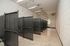 Spacious and modern indoor pet kennel area with multiple enclosures and sleek lighting, perfect for pet owners.