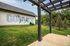 Welcoming dog-friendly outdoor space with charming pergola, vibrant greenery, and playful mural for pet enthusiasts.