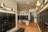 Elegant mailroom with sleek black mailboxes, polished wood floors, and modern gold lighting fixtures.